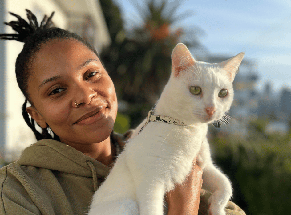 Phola holding a white cat