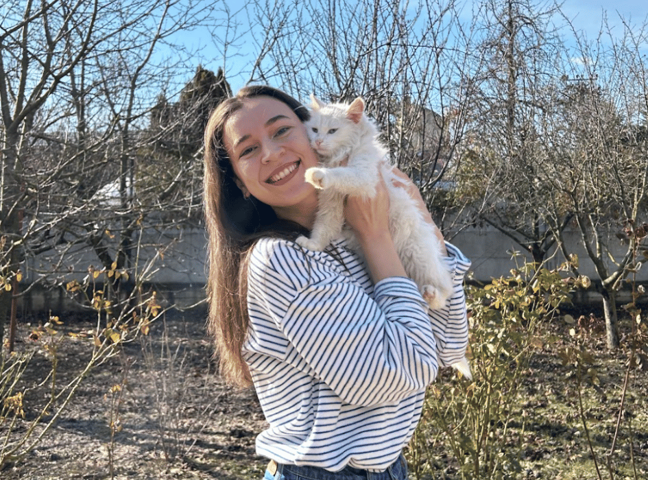 Ana holding a white cat